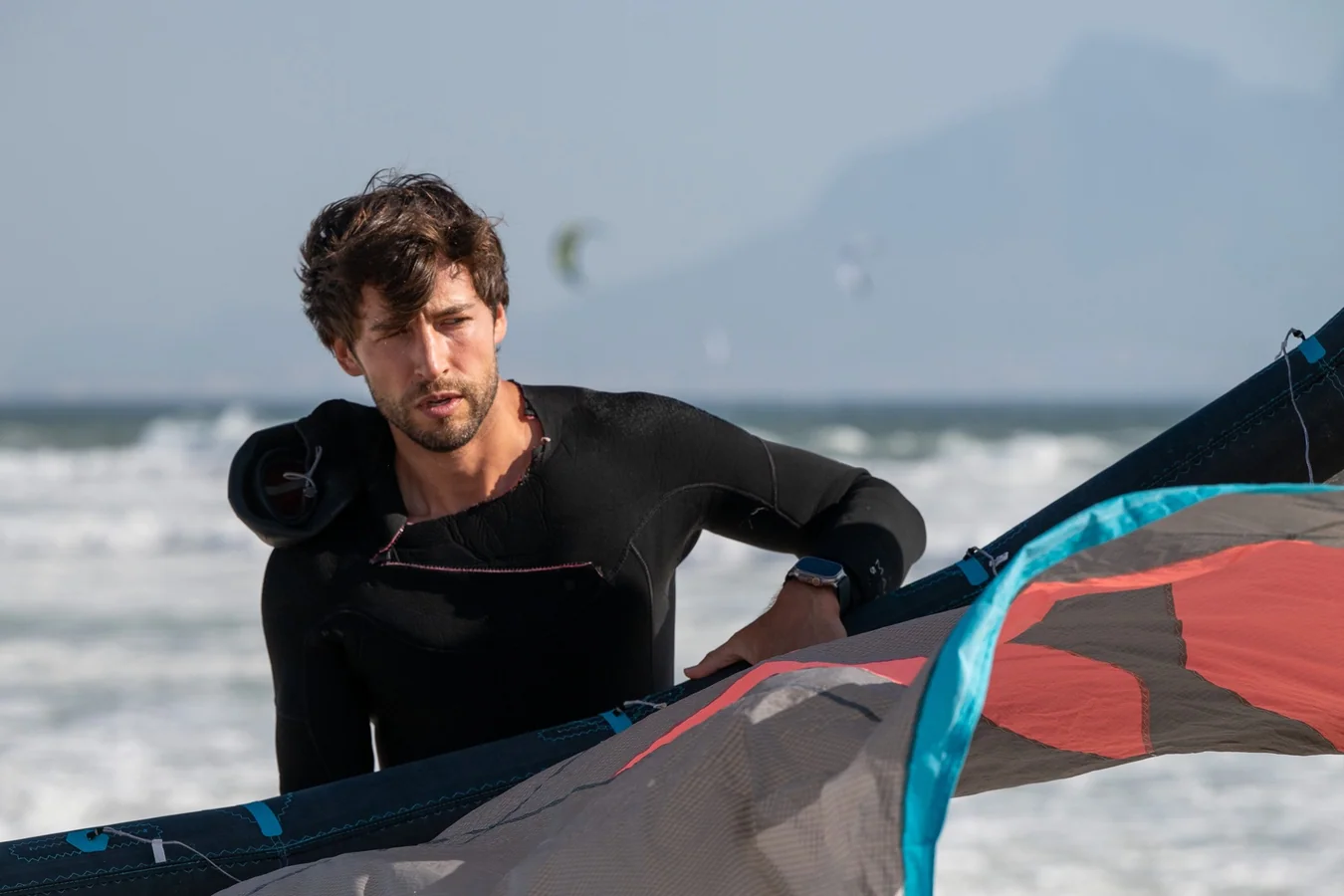 Shawn with kitesurfing gear on the beach